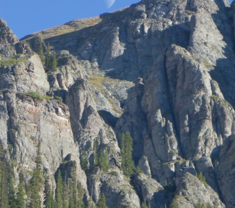 Moon rising above the rugged cliffs of Bear Creek Canyon near Telluride, Colorado