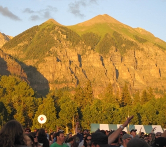 Telluride Bluegrass Festival crowd in Town Park beneath the mountains