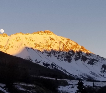 Moonrise and winter alpenglow above Ophir Pass near Ophir, Colorado