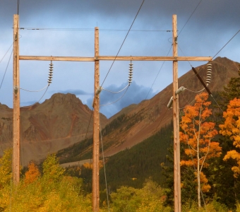 Ophir Pass framed by power lines and golden aspens in autumn near Ophir, Colorado