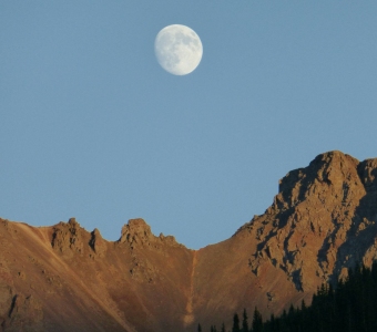 Moon above the rugged mountains near Ophir Pass, Colorado