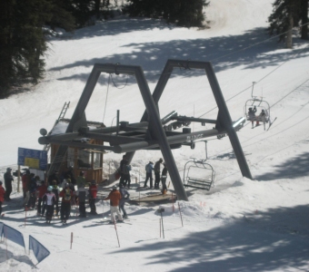 Skiers boarding the old Plunge Lift, Lift 9, at Telluride Ski Resort.