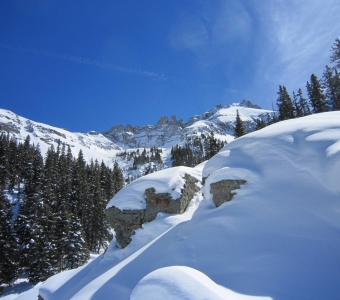 Snow-covered terrain in lower Prospect Bowl, with Palmyra Peak to the upper right and the Gold Hill chutes to the upper left at Telluride Ski Resort.