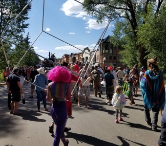 Telluride Mushroom Festival parade moving through downtown Telluride with costumed participants